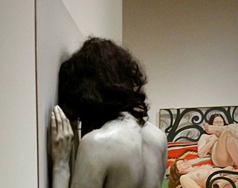 woman facing wall by John Andrea